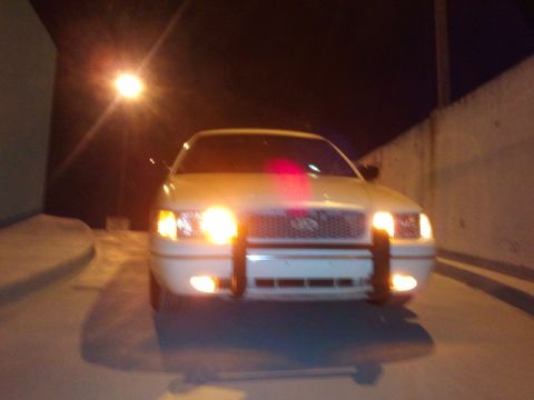 1998 Ford Crown Victoria - Front view of a 1998 Ford Crown Victoria parked at night.