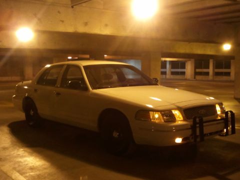1998 Ford Crown Victoria - This police car is parked in a garage with overhead lighting.