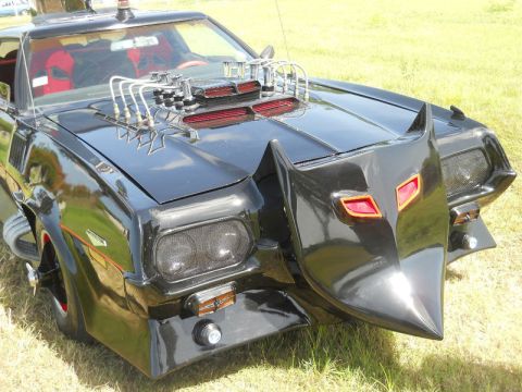 1971 Ford Ranchero - This heavily modified vehicle features a unique bat-inspired front end and a prominent engine intake.