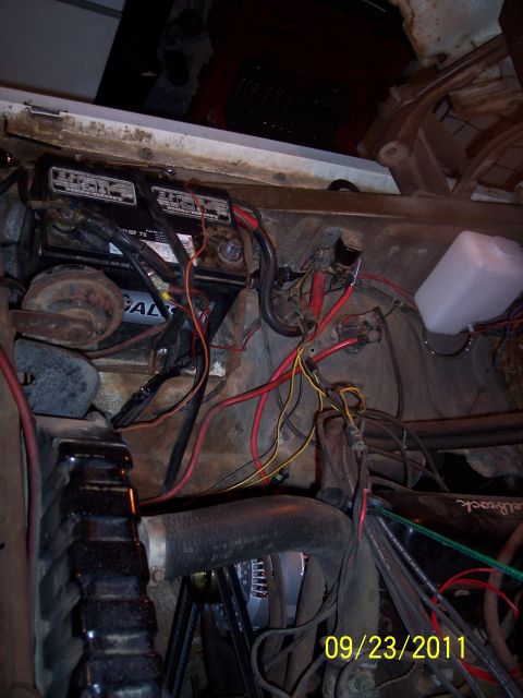 1973 Ford F-250 - The engine bay shows a battery, radiator, and a complex network of wiring. The photo was taken on September 23, 2011.