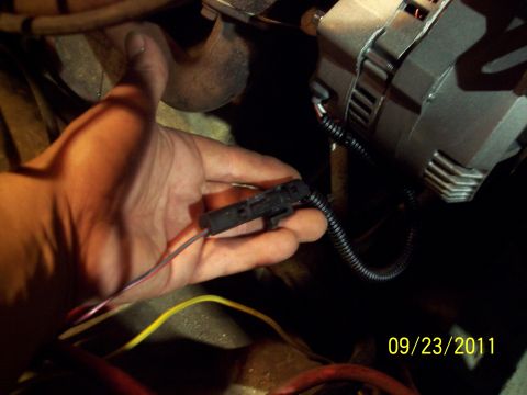 1973 Ford F-250 - Hand holding an electrical connector near an alternator, with a date stamp of 09/23/2011.