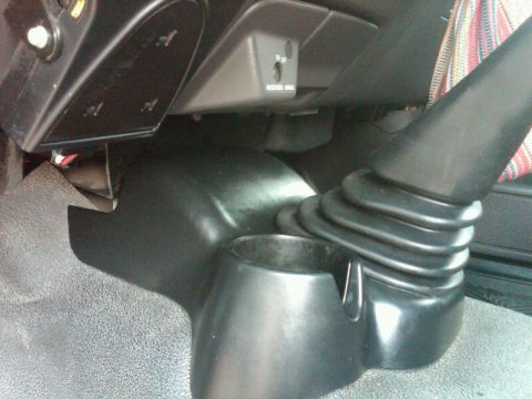 2003 Ford Ranger - Interior view of a vehicle's center console, showing the gear shifter and a passenger airbag switch.