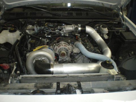 2004 Ford Crown Victoria - Engine bay modified with a supercharger system and custom piping.