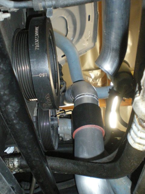 2004 Ford Crown Victoria - Close-up view of engine bay components, focusing on a supercharger system installation.