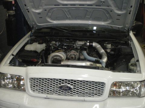 2004 Ford Crown Victoria - Engine bay of a 2004 Ford Crown Victoria modified with a turbocharger system.