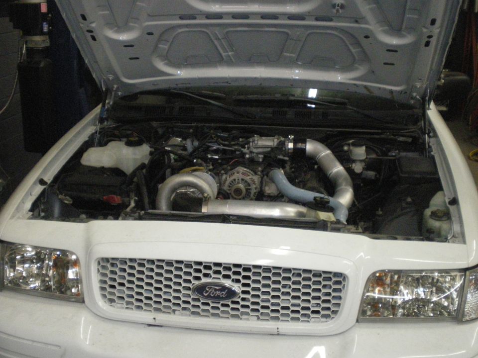2004 Ford Crown Victoria engine bay with turbocharger and custom intake piping