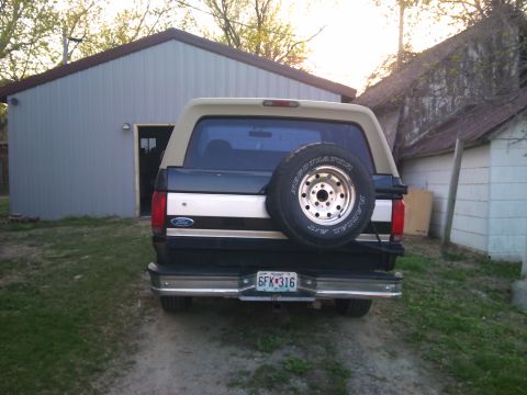 1994 Ford Bronco - This Ford Bronco has a two-tone paint scheme and a rear-mounted spare tire, typical of models from the early to mid-1990s.