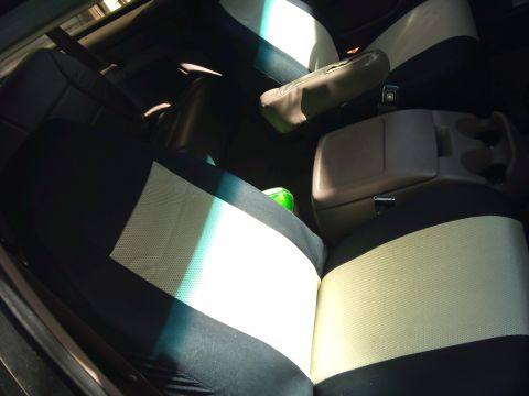 1994 Ford Bronco - The interior of a 1994 Ford Bronco shows two-tone seat covers and a center console.