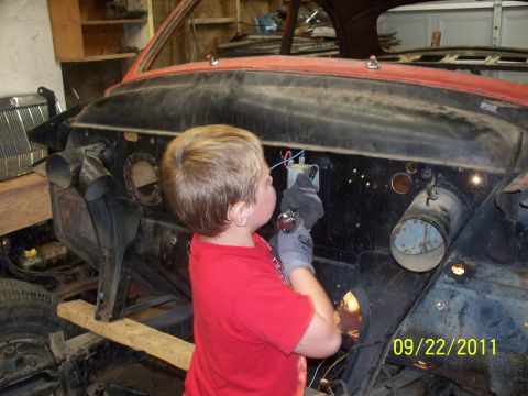 1990 Ford Bronco - A young child wearing gloves works on the engine bay of a vintage car, with the date 09/22/2011 visible.