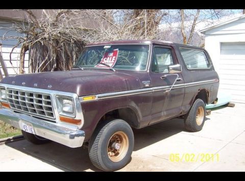 1979 Ford Bronco - This older model Ford Bronco is parked outside a garage with a 'For Sale' sign visible in the window.