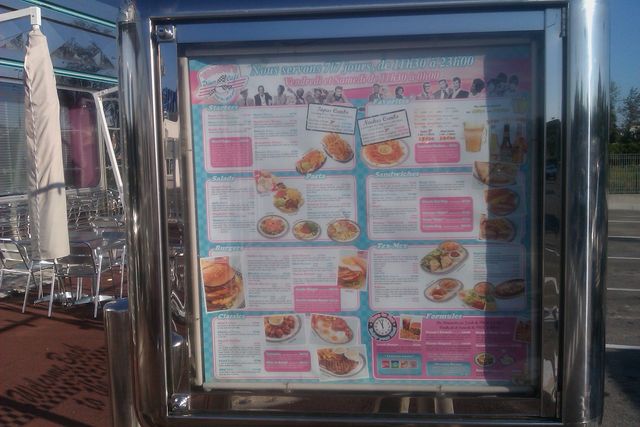 Photo of an illuminated American diner menu board mounted outdoors