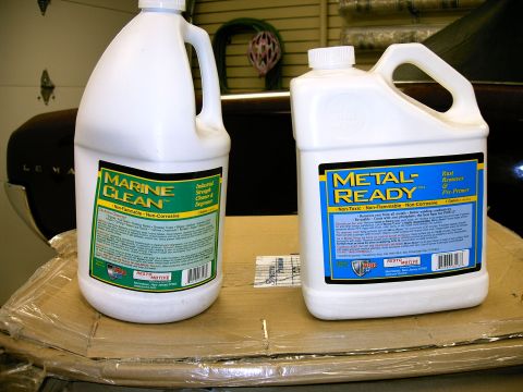 1990 Ford Bronco - Two bottles of automotive cleaning products, Marine Clean and Metal-Ready, are displayed on a cardboard surface.