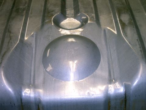 1990 Ford Bronco - Interior view of a metal fuel tank, showing embossed structural details.