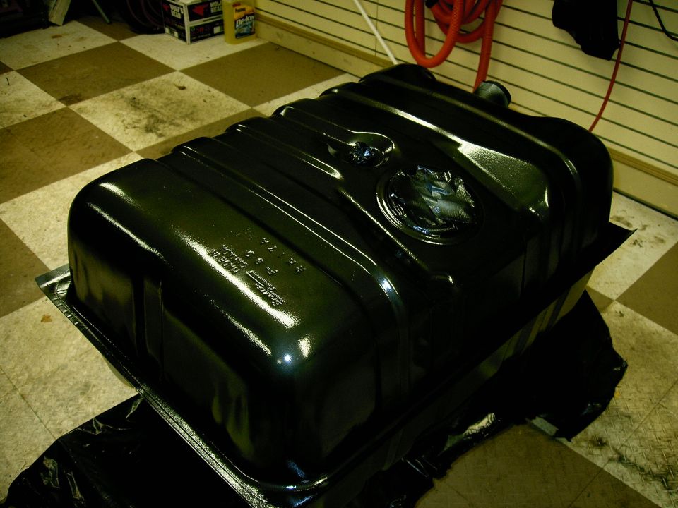 Black fuel tank with embossed text and circular emblem