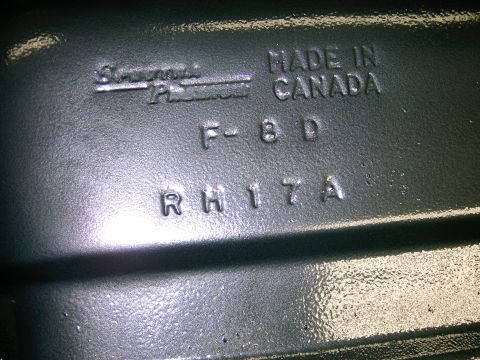 1990 Ford Bronco - Close-up of embossed markings on a manufactured part, including brand and origin.