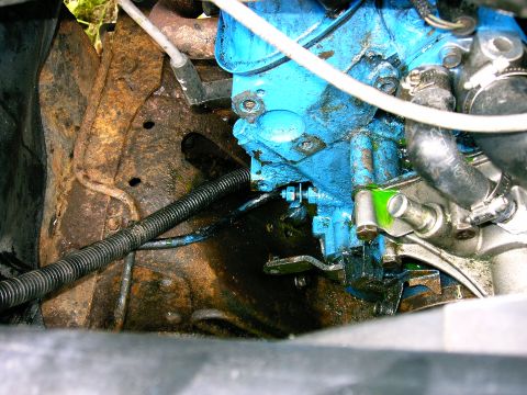 1990 Ford Bronco - Engine component with blue paint and a visible leak of green fluid.