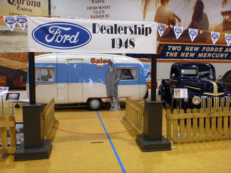 1948 Ford dealership display a blue and white trailer and a dark blue Ford pickup truck with a yellow stripe