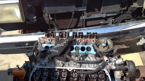 1990 Ford Bronco - Engine block disassembled, revealing internal components like rocker arms and pushrods.