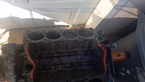 1990 Ford Bronco - Engine block shown in a disassembled state, with an orange support visible.