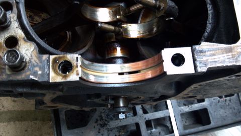 1990 Ford Bronco - Engine crankshaft bearings are visible in this close-up view, some showing signs of wear.