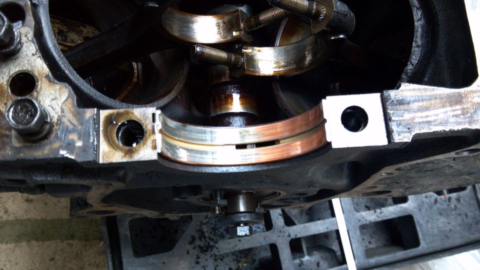 Close-up of engine crankshaft bearings, some showing wear