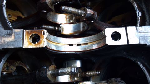 1990 Ford Bronco - This image shows the internal components of an engine, specifically the crankshaft bearings and connecting rod caps.