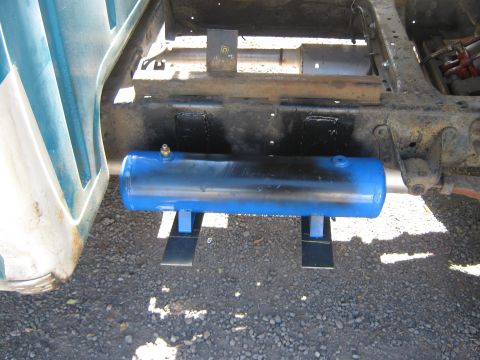 1972 Ford F-250 - A blue cylindrical air tank is mounted beneath the frame of a truck, secured by brackets.