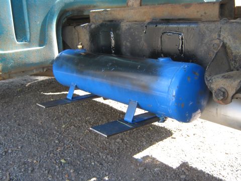 1972 Ford F-250 - A blue air tank is mounted to the frame of a teal vehicle.