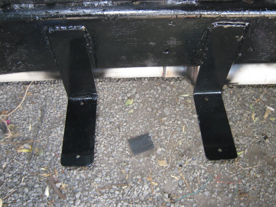 Black painted frame brackets on a vehicle undercarriage