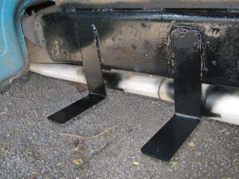 1972 Ford F-250 - Custom fabricated step brackets are attached to the frame of a truck, near the exhaust system.