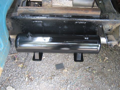 1972 Ford F-250 - A close-up view of a newly installed black air tank on the underside of a vehicle.