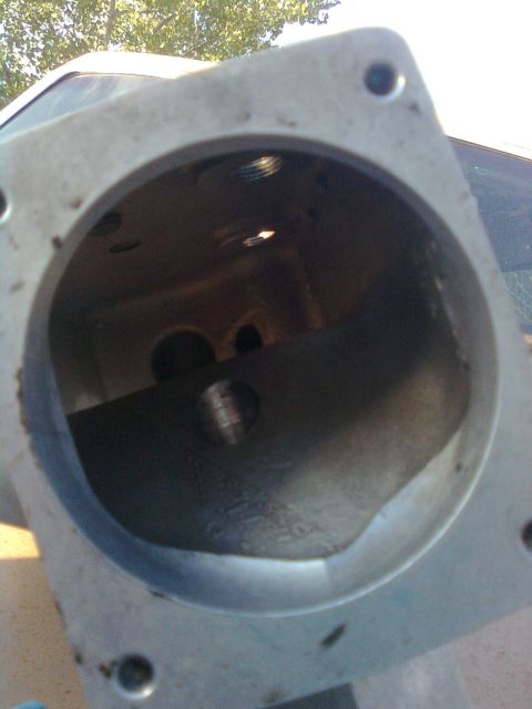 1984 Ford Bronco - This image shows a close-up of an engine part, with a website logo in the corner.