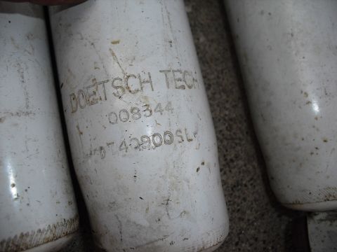 1986 Ford Bronco - Several white oil filters are shown, with some text visible on one of them.