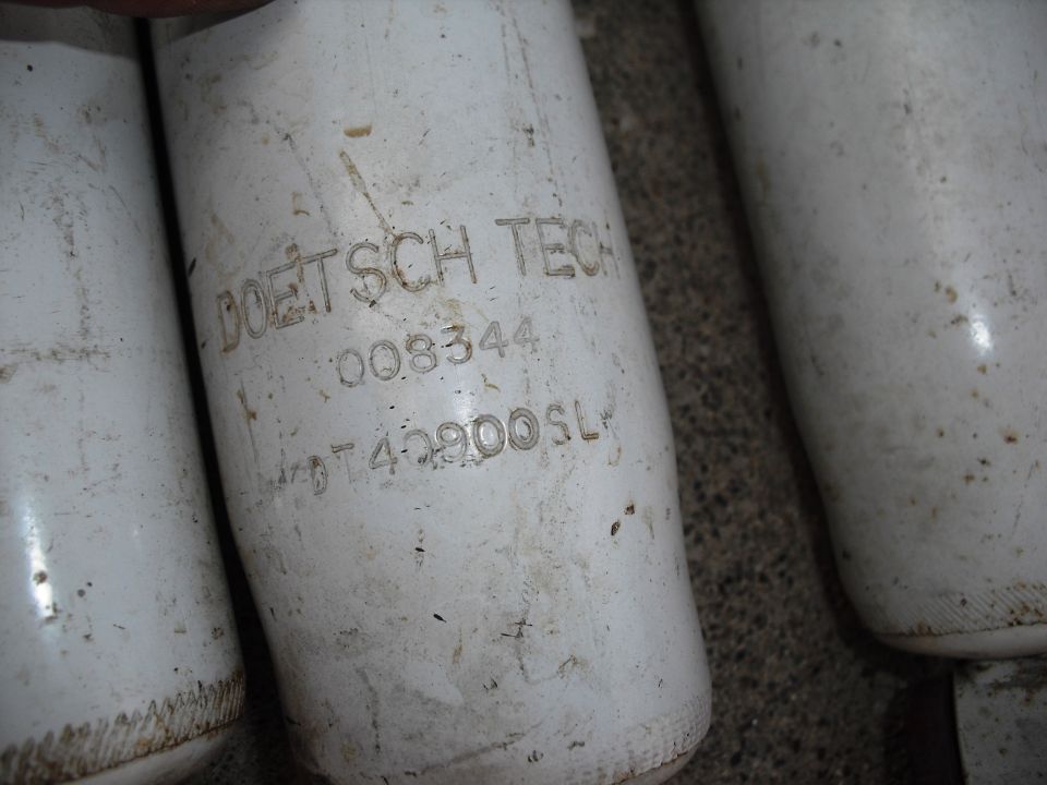 Close-up of white oil filters with text 'DOETSCH TECH 008344 0T42900SL'