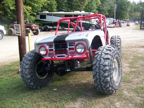 2001 Dodge 1500 - Custom off-road buggy features a prominent red roll cage and oversized tires for extreme terrain.