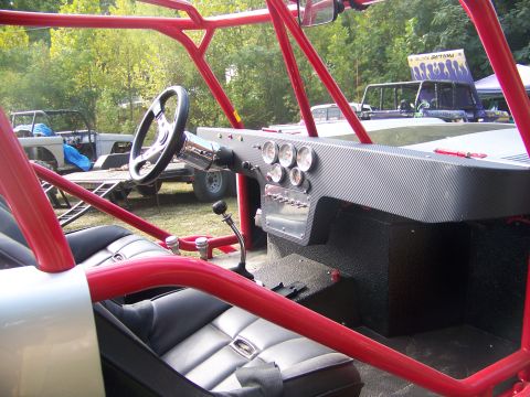 2001 Dodge 1500 - Custom buggy interior features a roll cage, aftermarket seats, and a carbon fiber dash with multiple gauges.