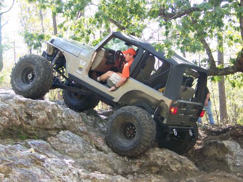 2001 Dodge 1500 - A modified Jeep Wrangler navigates a rocky trail during an off-road excursion.