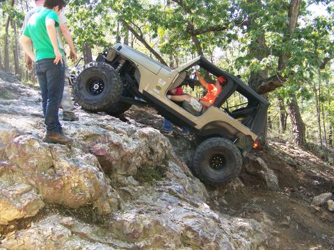 2001 Dodge 1500 - A Jeep Wrangler navigates a difficult rocky terrain on an off-road trail.
