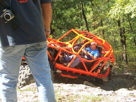 2001 Dodge 1500 - Driver navigates an orange off-road buggy through a rocky, wooded trail.