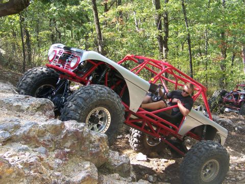 2001 Dodge 1500 - A custom off-road buggy navigates a rocky trail with a driver visible.