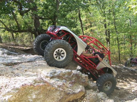 2001 Dodge 1500 - Custom off-road buggy navigates a challenging rocky trail with a driver in the cockpit.