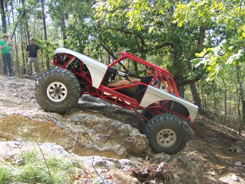 2001 Dodge 1500 - Custom buggy with red roll cage navigates a rocky off-road trail.