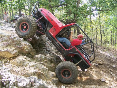 2001 Dodge 1500 - A heavily modified Jeep navigates a steep, rocky trail with a second vehicle in the background.