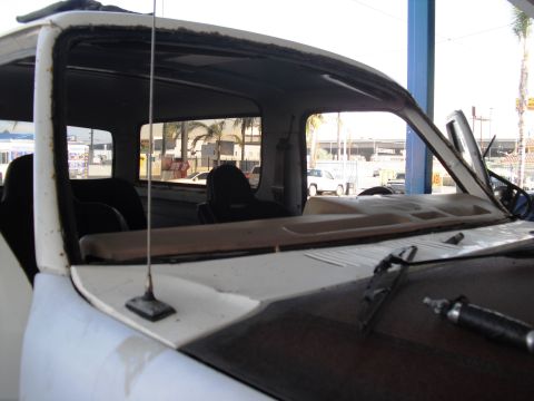 1986 Ford Bronco - The interior of a 1986 Ford Bronco shows the windshield removed, revealing the dashboard and seats.