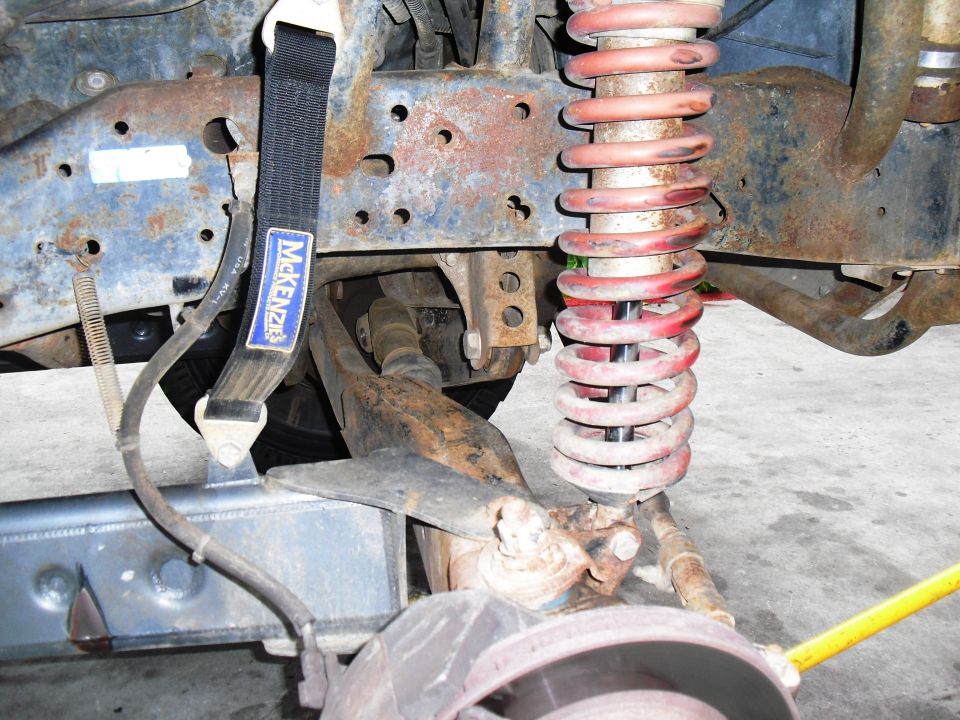 McKenzie tow strap attached to rusty suspension components