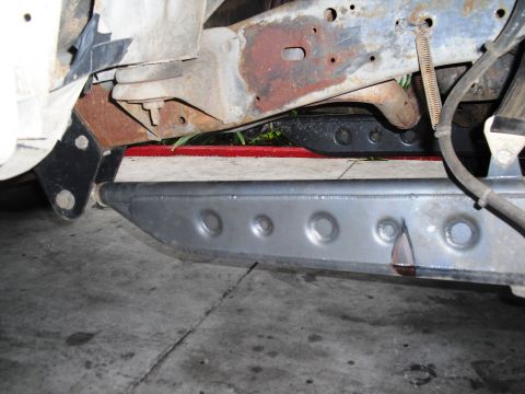 1986 Ford Bronco - Undercarriage view showing frame, suspension, and a custom metal slider attached.