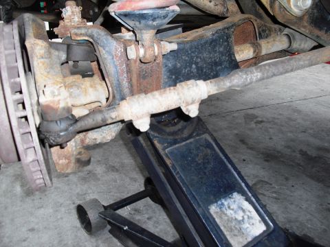 1986 Ford Bronco - Close-up of heavily rusted vehicle suspension and steering components.