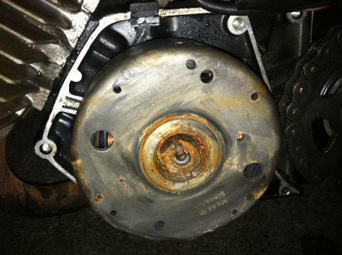 1999 Tomos Targa - Close-up of a rusty flywheel, likely from a motorcycle engine, with manufacturing details visible.