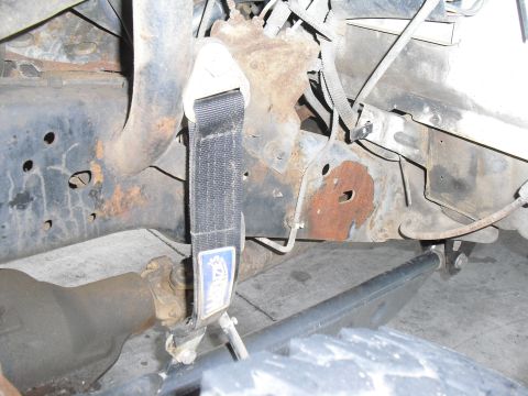 1986 Ford Bronco - Undercarriage view showing frame rust and suspension components, no year identifiable.