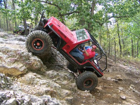 2001 Dodge 1500 - Off-road vehicles navigate a rocky trail in a wooded area.